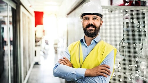 Safety Manager standing in plant with arms folded