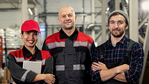 Group of Maintenance Professionals Standing Together in Industrial Plant